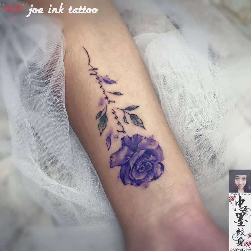 Purple rose tattoo with leaves on forearm