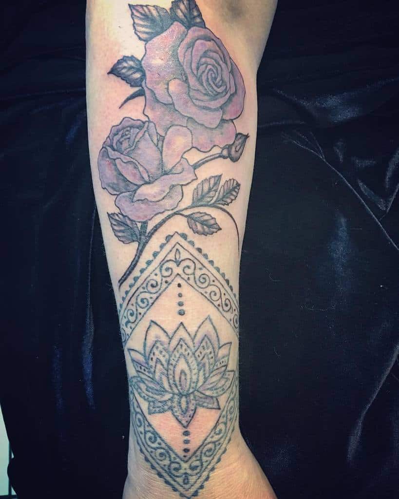 A forearm tattoo showcasing a stunning purple rose intertwined with a geometric lotus design