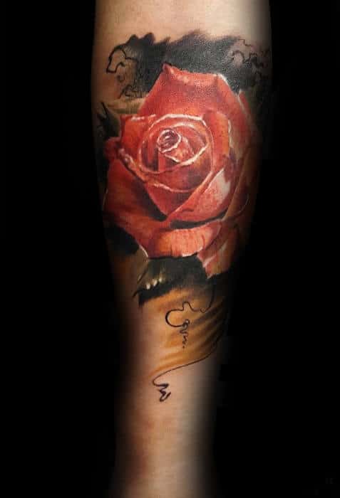 Tattoo of a realistic red rose on a person's arm, with cursive writing below