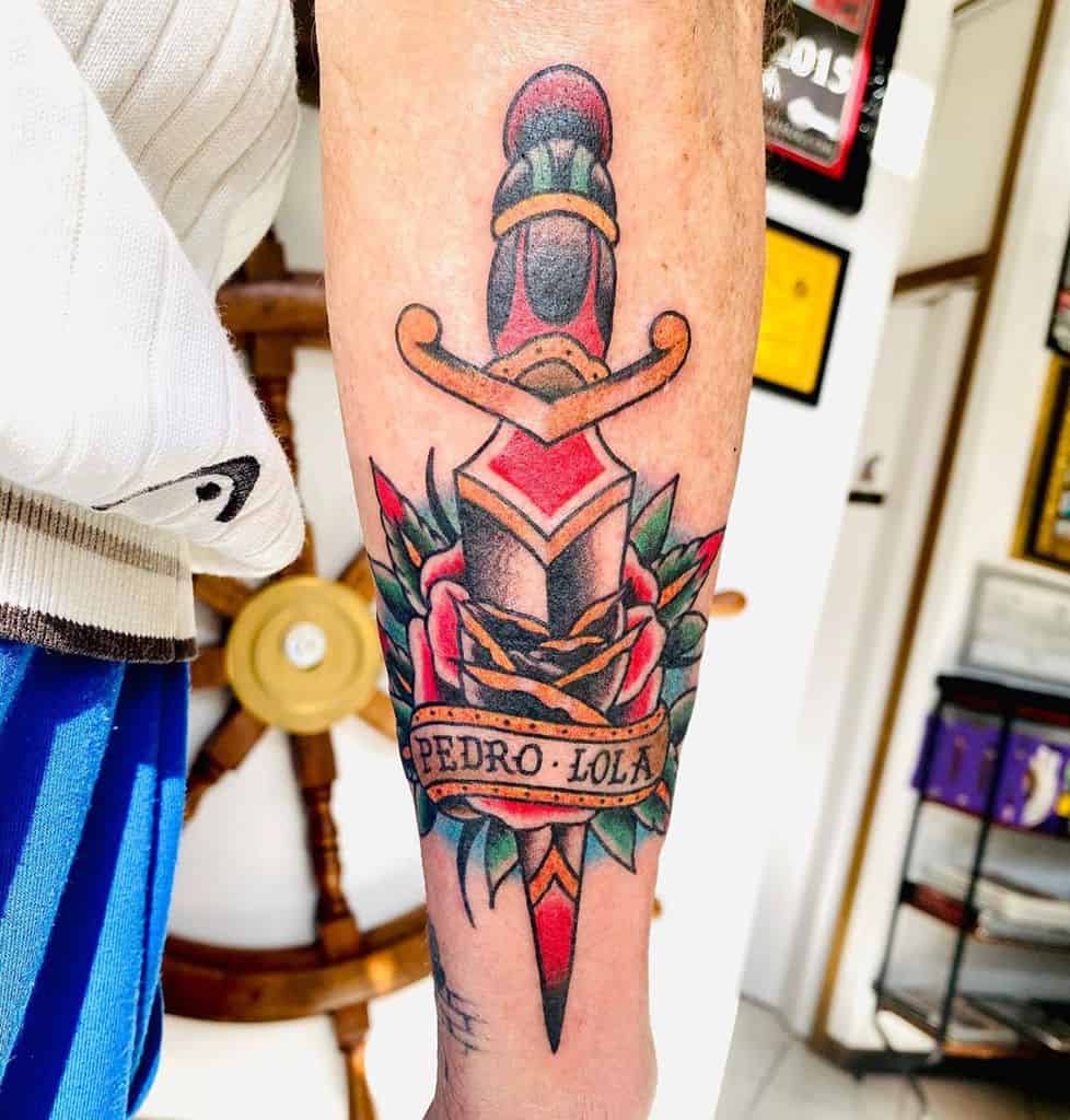 Tattoo of a dagger through a rose with "Pedro Lola" banner on a forearm