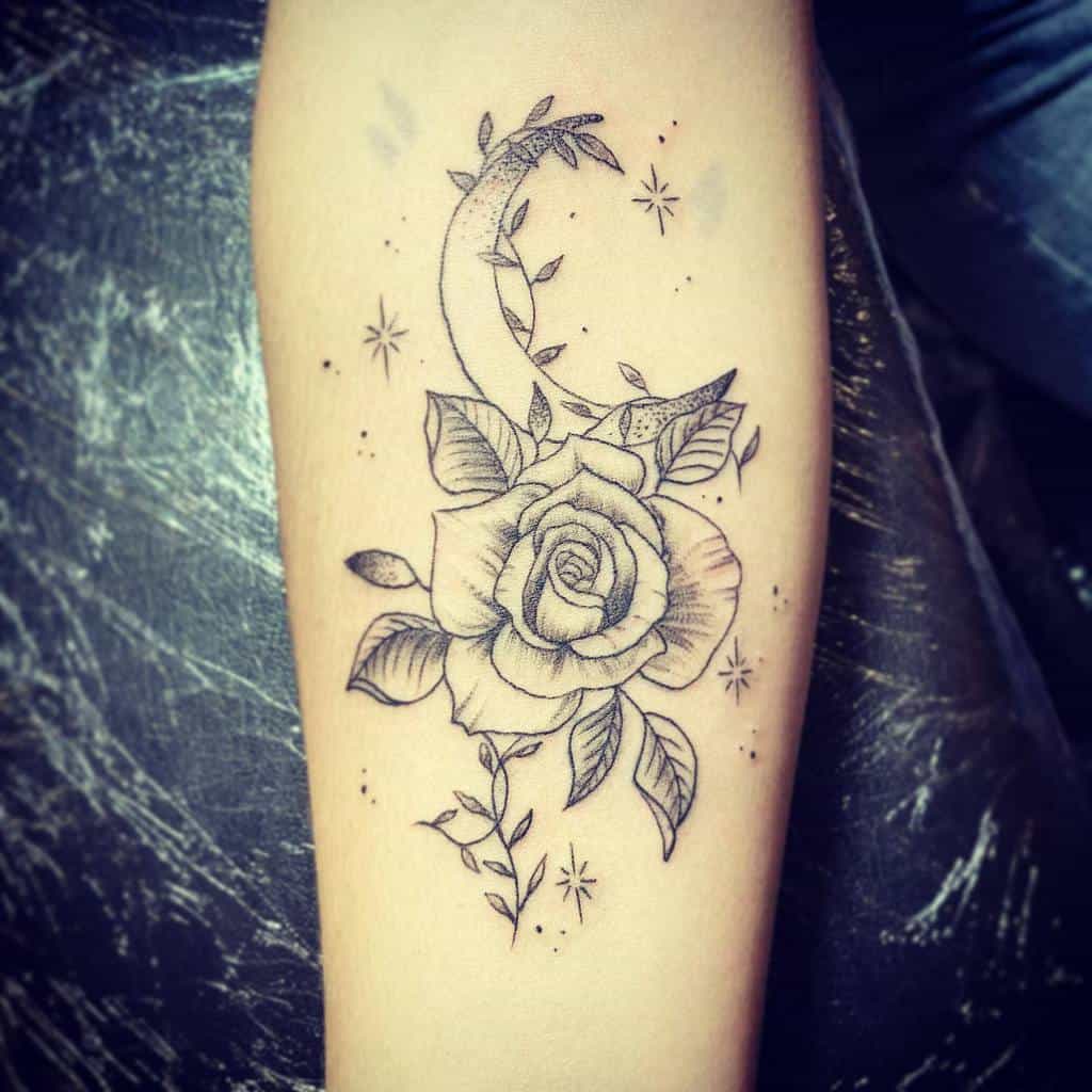 Delicate forearm tattoo featuring a rose with a crescent moon and subtle stars, surrounded by leafy accents for a celestial floral design
