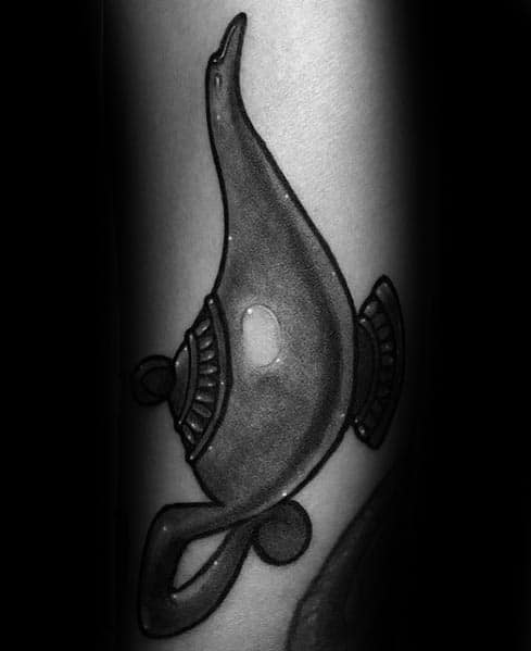 Tattoo of a stylized genie lamp with intricate patterns on a person's skin