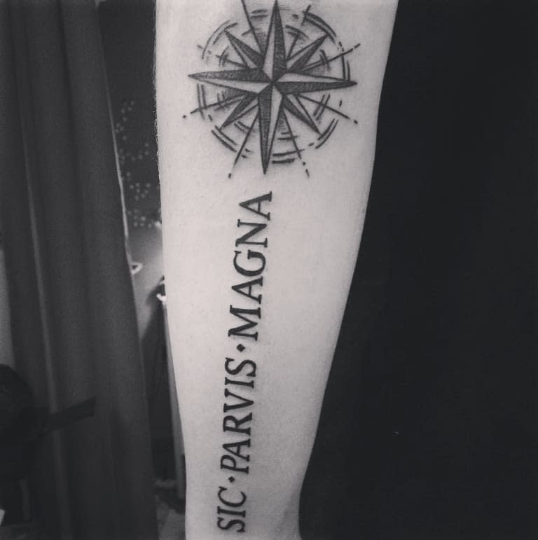 Forearm tattoo with a compass rose and the words "Sic Parvis Magna"