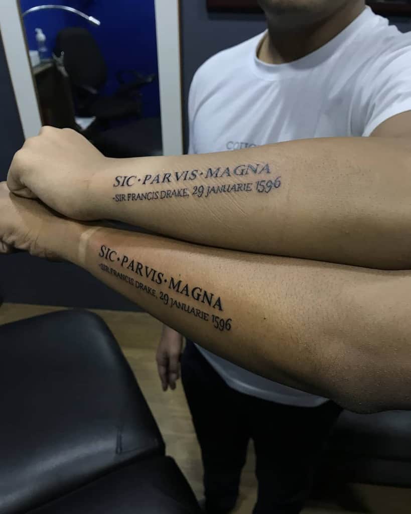 Two people showing matching forearm tattoos that read: "Sic Parvis Magna, Sir Francis Drake, 29 Januarie 1596"