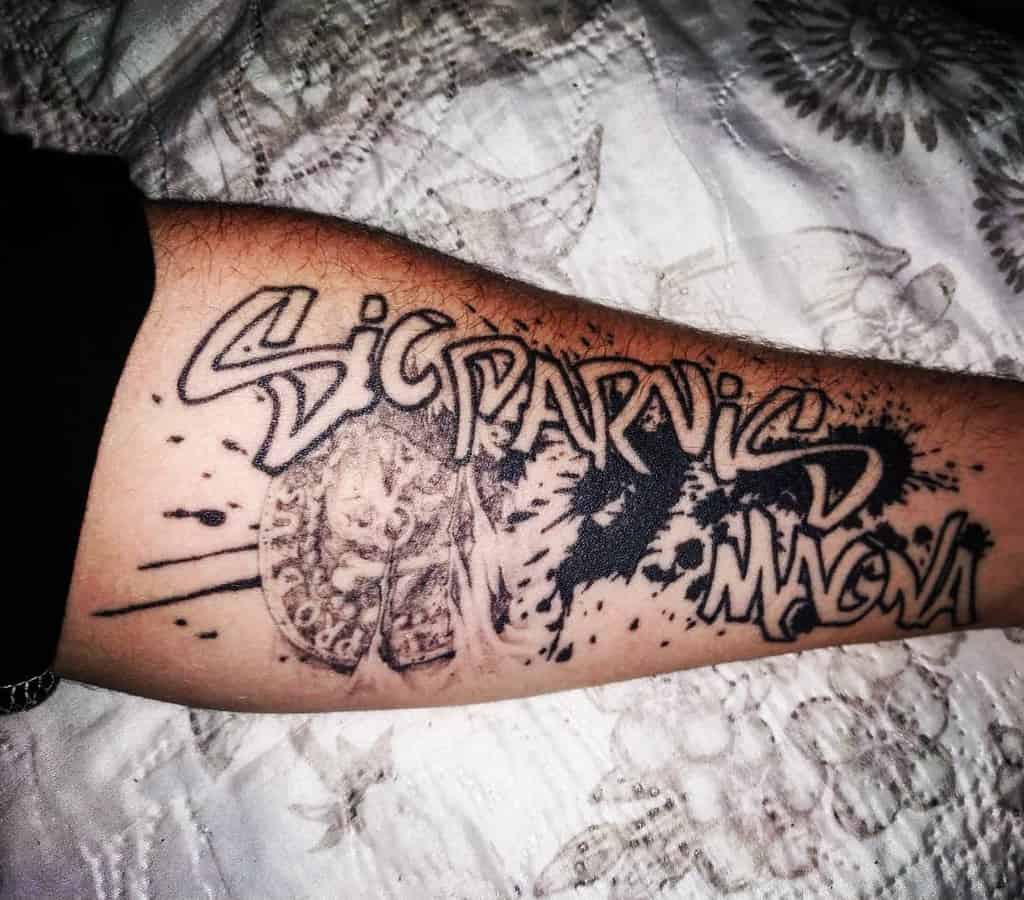 Forearm tattoo with abstract design and the words "Sic Parvis Magna" in bold lettering