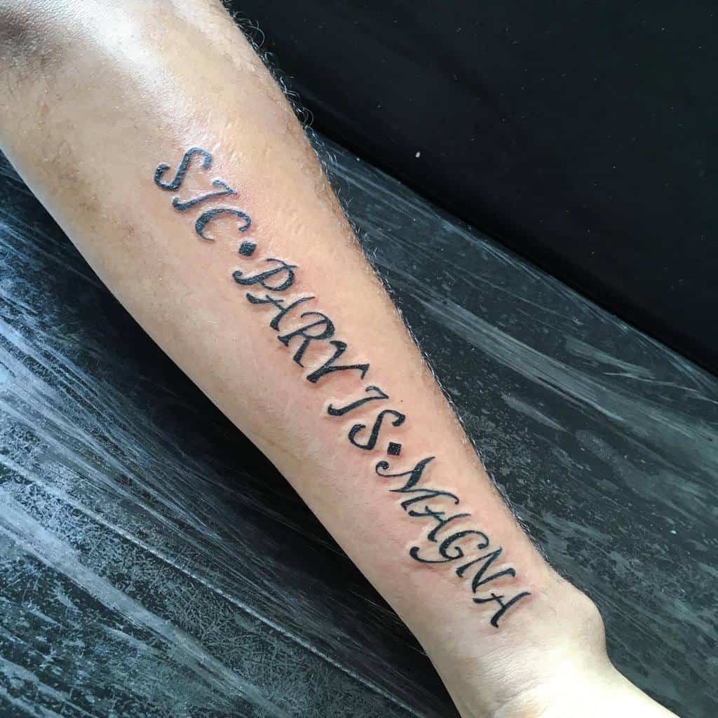 Forearm with a tattoo that reads "Sic Parvis Magna" in stylized script