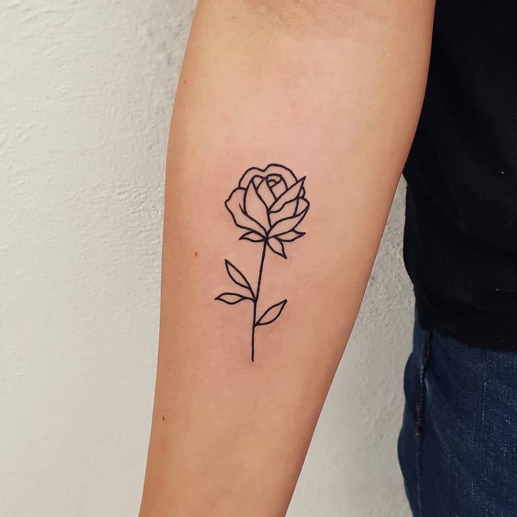 Line art rose tattoo on a person's forearm