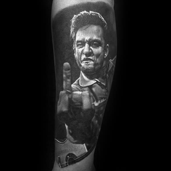 Tattoo of Johnny Cash holding a guitar and making a hand gesture