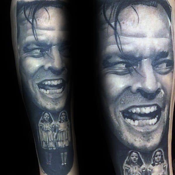Detailed portrait tattoo inspired by a famous horror movie scene, featuring a man with a sinister grin and two eerie girls standing below