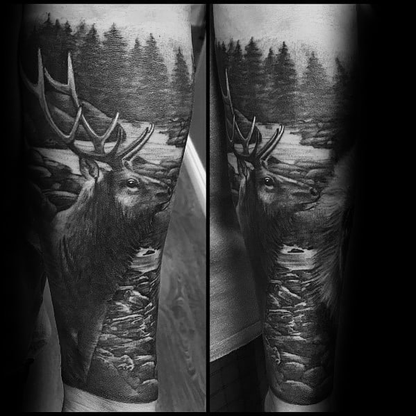 Realistic black and grey elk tattoo on the forearm, featuring a detailed forest and river background for a bold and nature-inspired design.