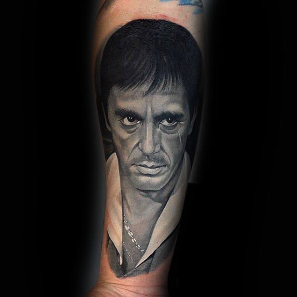 Realistic portrait tattoo of Al Pacino as Tony Montana from the iconic movie Scarface, showcasing his intense gaze and detailed facial features