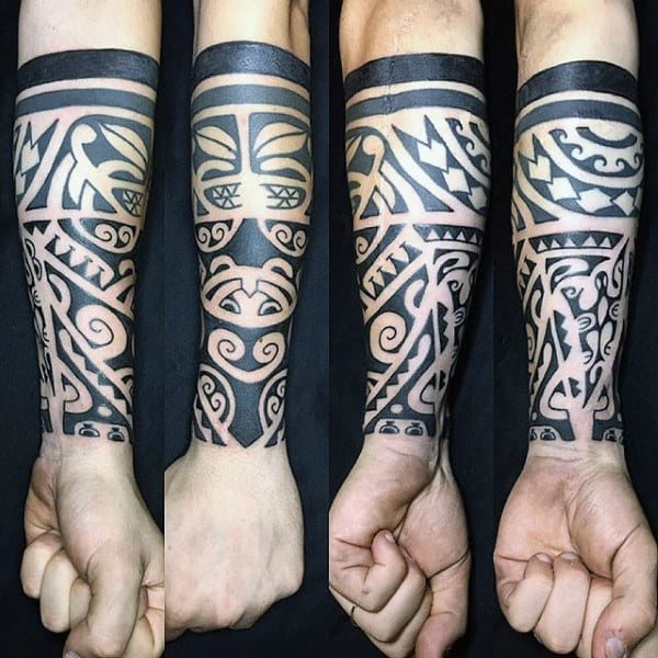 Four views of a forearm tattoo with intricate black geometric and tribal patterns
