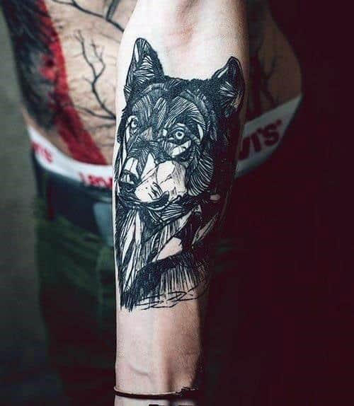 Forearm tattoo of a wolf with artistic, sketch-like design details