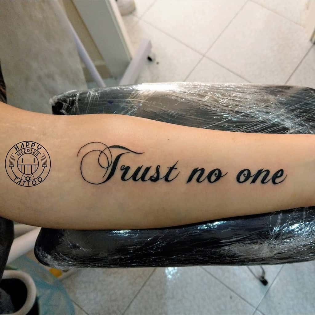 Tattoo on your forearm that reads "Trust no one" in cursive script