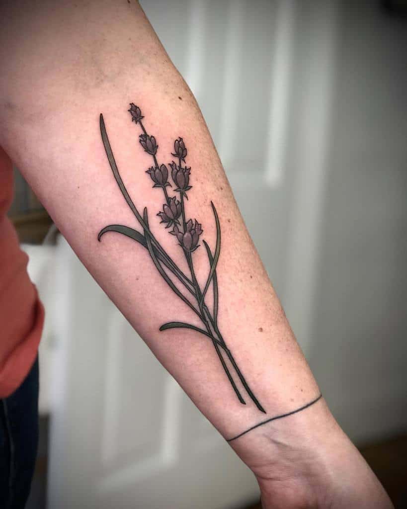 Tattoo of a lavender sprig on a person's forearm with a simple bracelet line