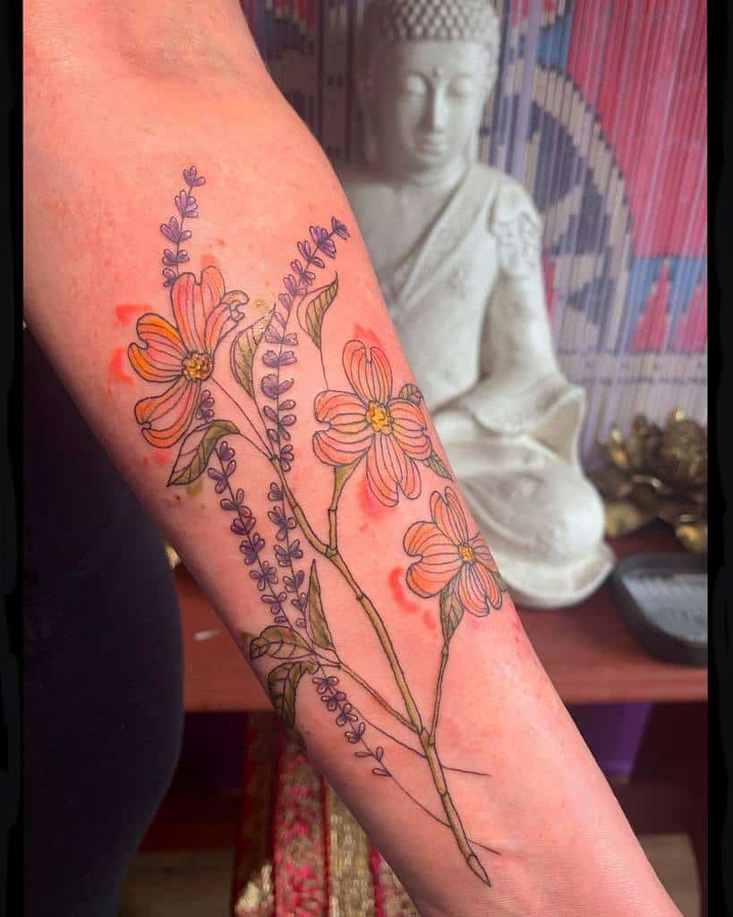 Colorful forearm tattoo featuring orange wildflowers, purple lavender sprigs, and green leaves in a delicate arrangement