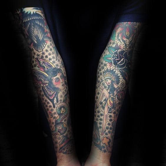 Forearms covered with colorful detailed tattoos including figures and floral designs