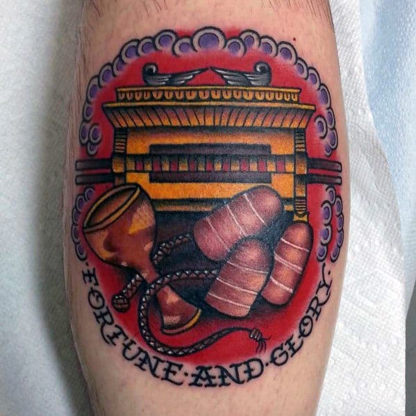 Indiana Jones tattoo featuring the Ark of the Covenant, Holy Grail, whip, and hat, with 'Fortune and Glory' inscribed below.