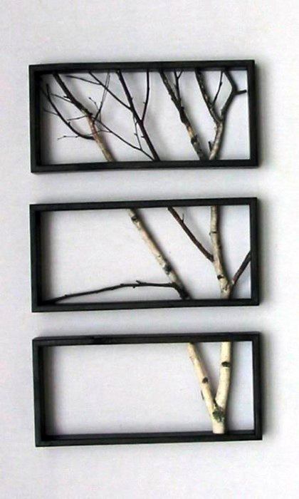 A minimalist wall art featuring framed tree branches offers a stylish, nature-inspired decor perfect for a modern bachelor pad.