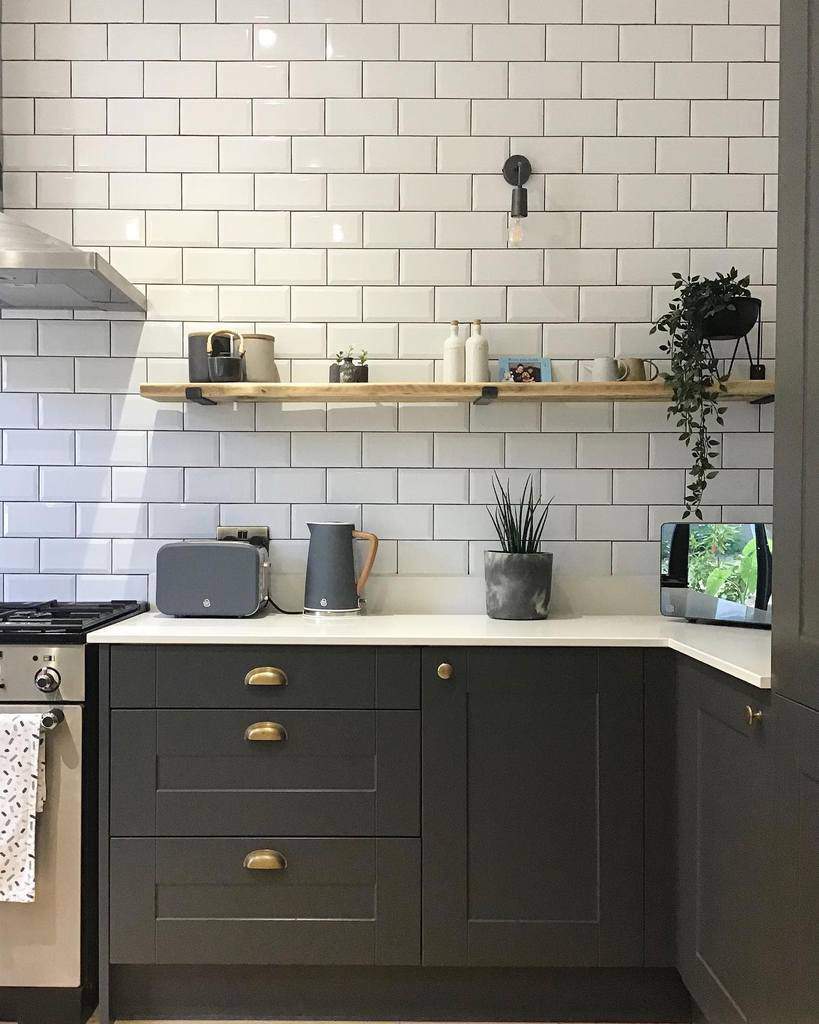 white subway tiles wood hanging shelf kitchen