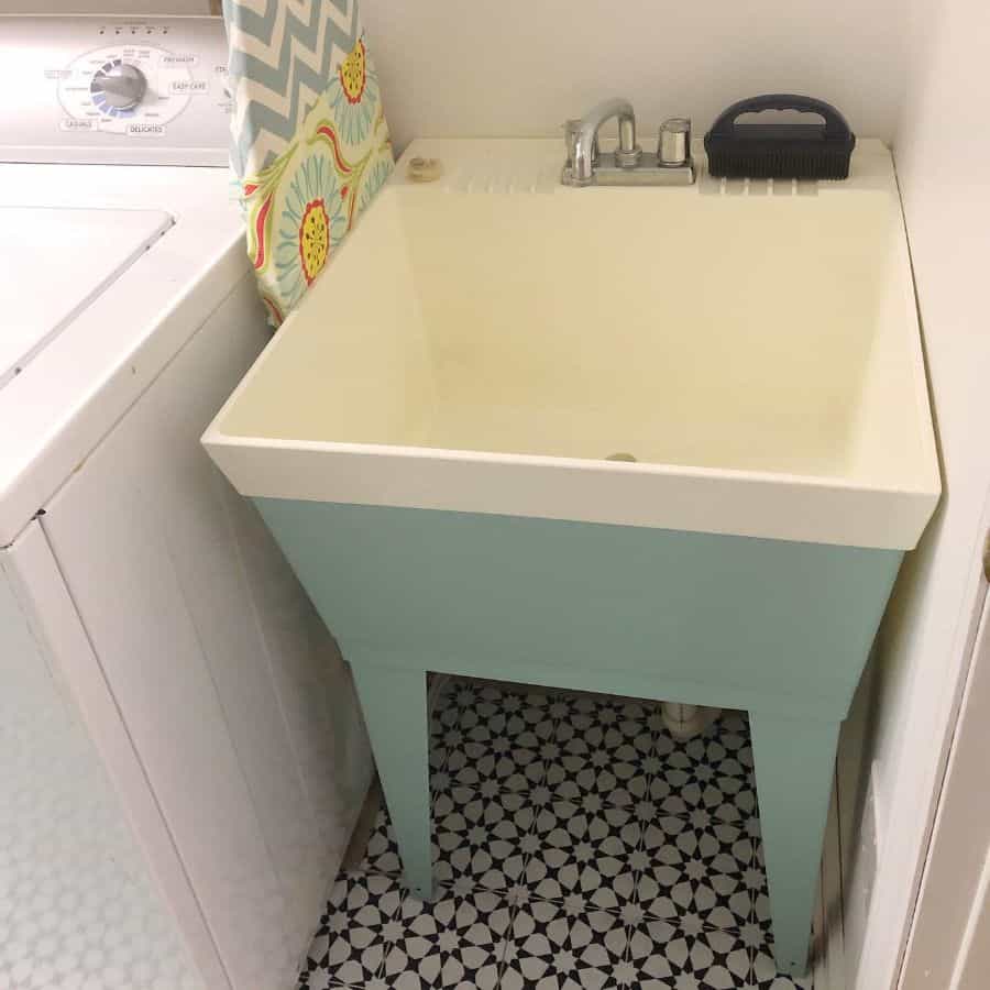 blue and white free standing sink laundry room
