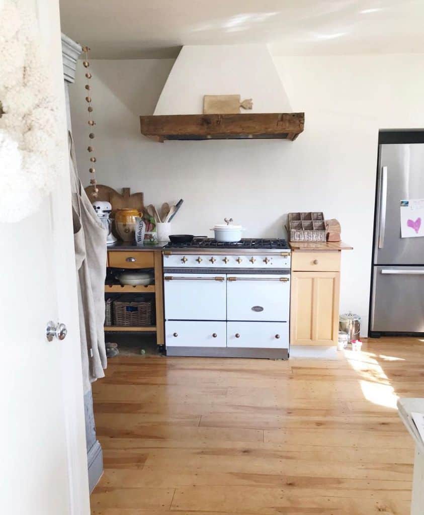 small basic kitchen wood floorboards white stove and oven wood cabinets 