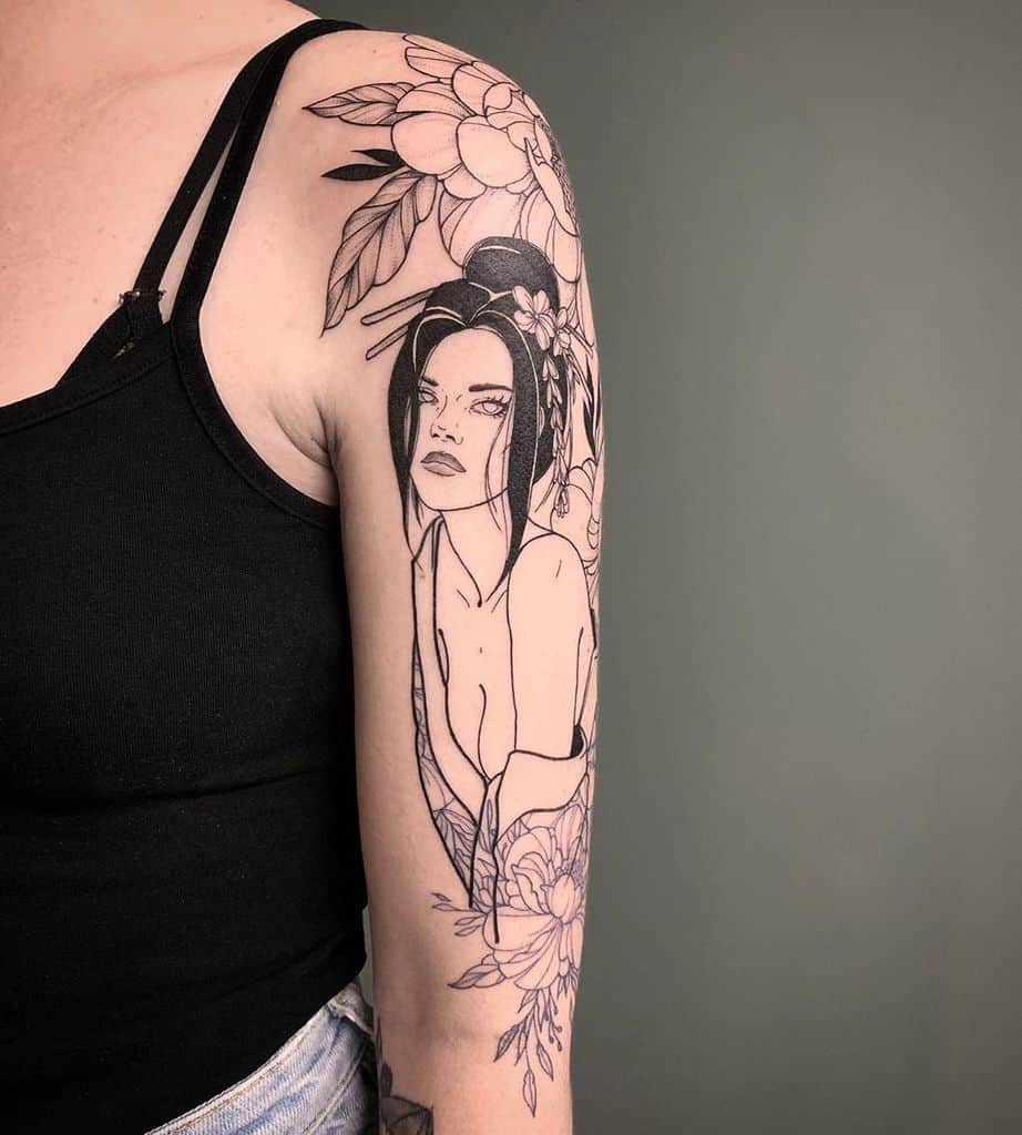 Elegant black linework tattoo of a Geisha with an intense gaze, intricate floral designs, and delicate shading covering the upper arm and shoulder.