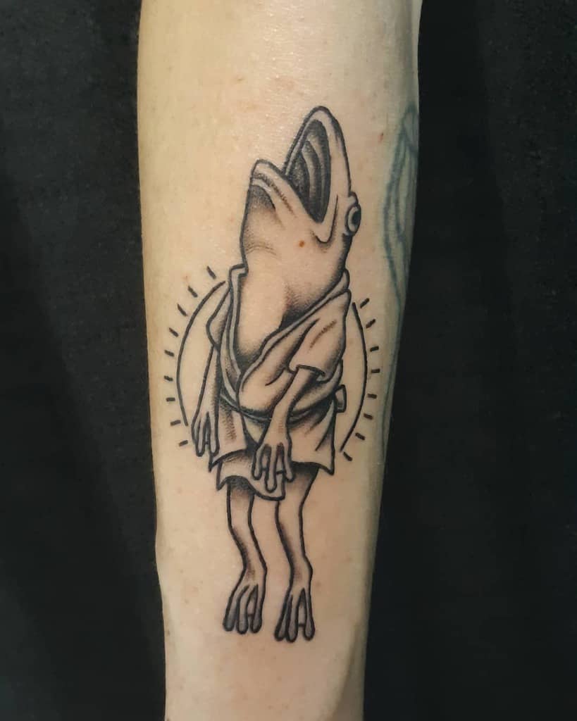 Black and grey tattoo of Aogaeru from Spirited Away, depicted mid-yell in a bathhouse robe, with fine linework and shading details