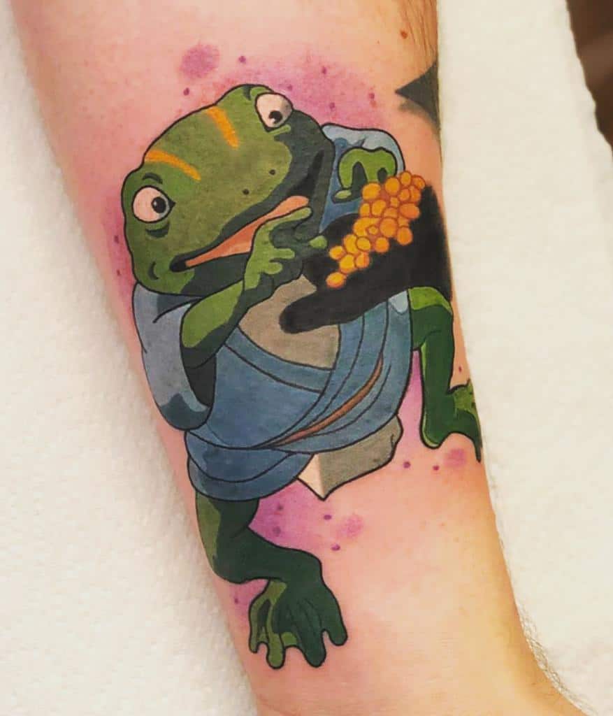 Colorful tattoo of the greedy frog spirit Aogaeru from Spirited Away, wearing a blue robe and clutching gold, with pink watercolor accents