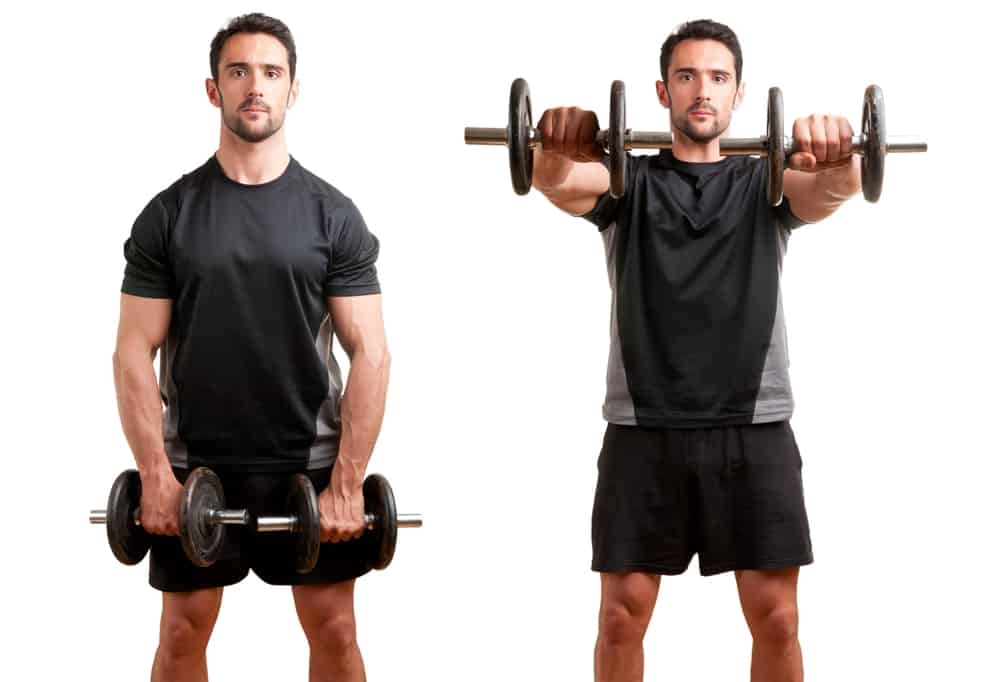 personal trainer doing front dumbell raises for training his deltoids