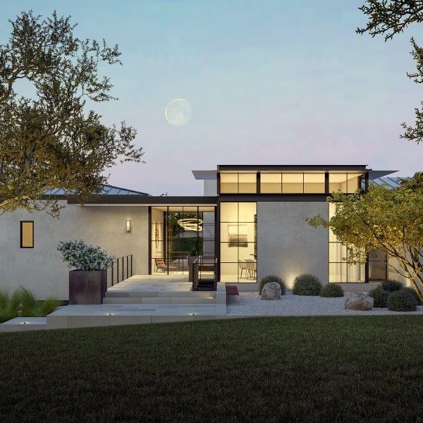 Modern home with glass windows, minimal landscaping, stone accents, and a twilight sky backdrop.