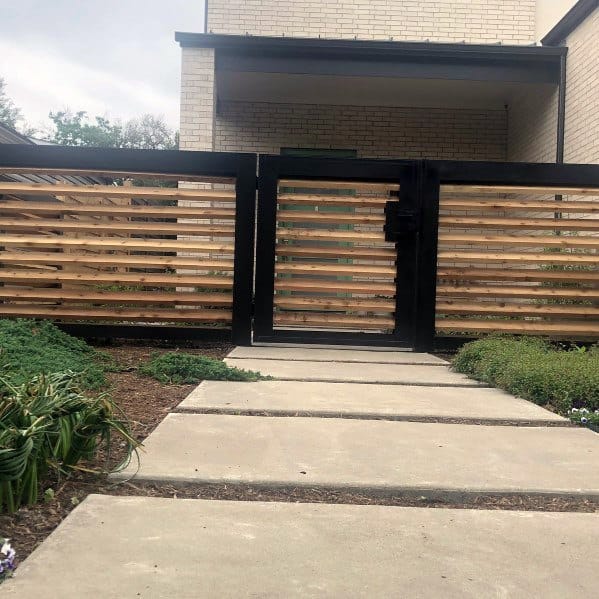 wood and metal front yard fence paver pathway 