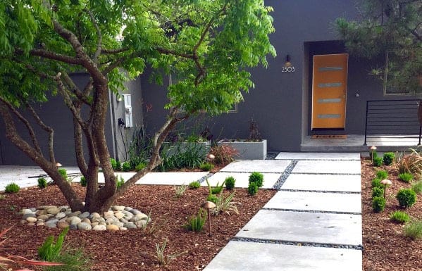concrete steps with landscaping pebbles 