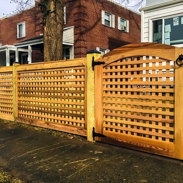 Fence and matching gate enhance brick and white house facades
