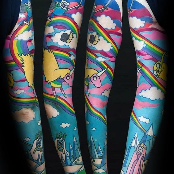 Full sleeve Adventure Time tattoo with vibrant skies, rainbows, Ice Kingdom, Princess Bubblegum, Lady Rainicorn, and flying characters.