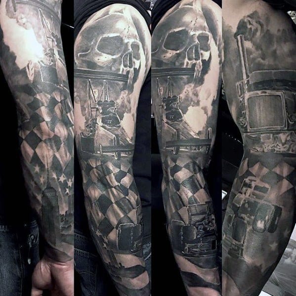 Full sleeve tattoo featuring a semi-truck, checkered flag, skull, and smoke clouds, done in a bold black and grey realism style.