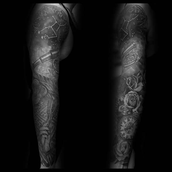 Black and gray tattoo sleeve on legs featuring constellations, a telescope, a pocket watch, roses, and intricate patterns
