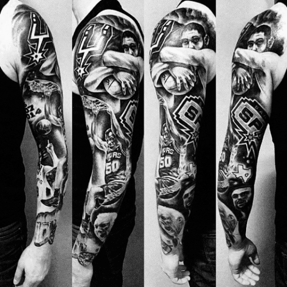 Full black and grey sleeve tattoo showcasing San Antonio Spurs legends, team logos, basketball moments, and portraits in a bold, dynamic layout.