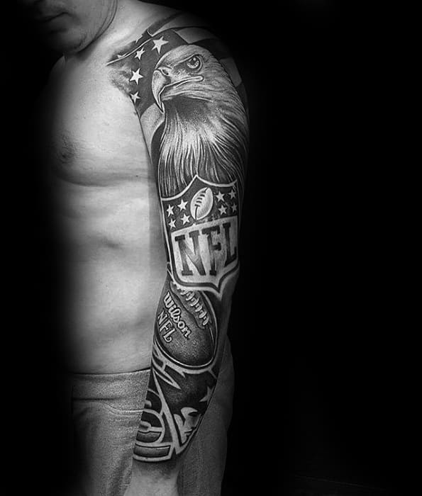 Bold black and grey NFL-themed sleeve tattoo featuring a fierce eagle, stars, football, and the official NFL logo with dynamic shading