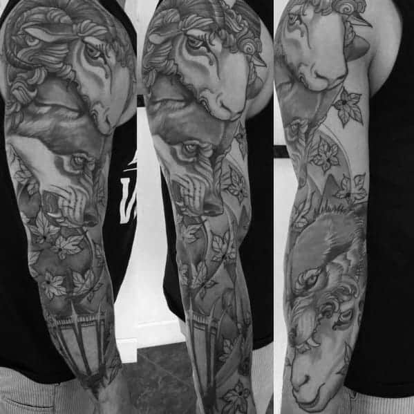 Black and gray full-arm sleeve tattoo featuring a detailed 'wolf in sheep's clothing' theme, with the wolf's face subtly blended into the sheep, surrounded by leaves and other decorative elements