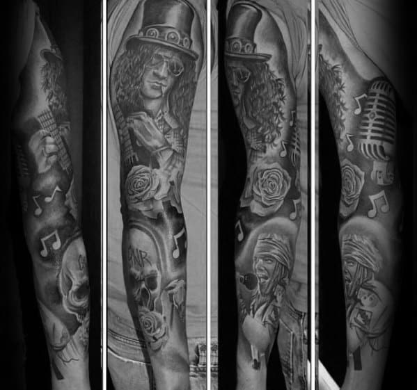 Full sleeve tattoo in black and grey featuring Slash, Axl Rose, music notes, roses, skulls, a microphone, and Guns N' Roses references.