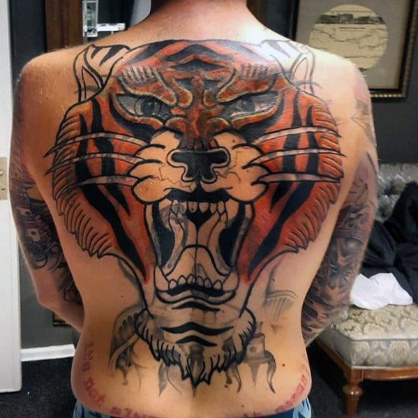 Man with a vibrant blast over tiger tattoo covering his back