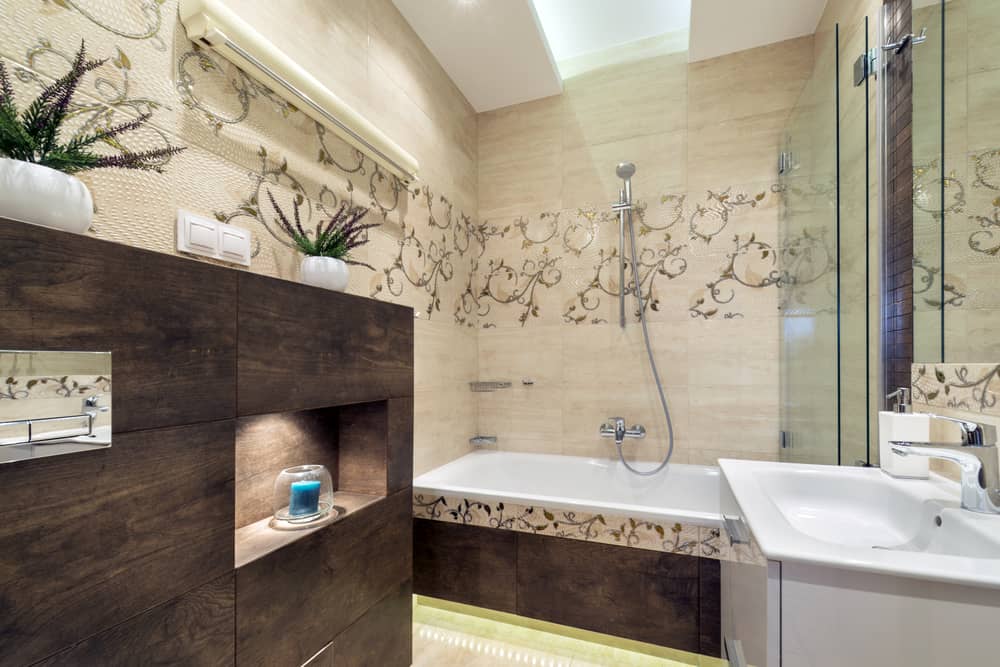 large bathroom with pattern wall tiles and bath/shower combo