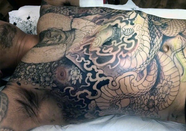 Full chest tattoo featuring a serene Buddha figure, swirling smoke patterns, a coiled dragon, and intricate cherry blossoms in a Japanese style