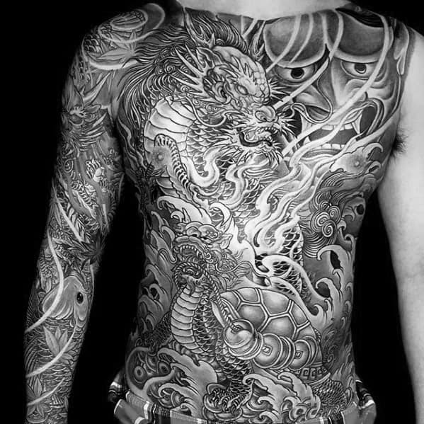 Intricate full-body black and grey tattoo featuring a fierce Kirin with detailed scales, flames, waves, and mythological mask elements.