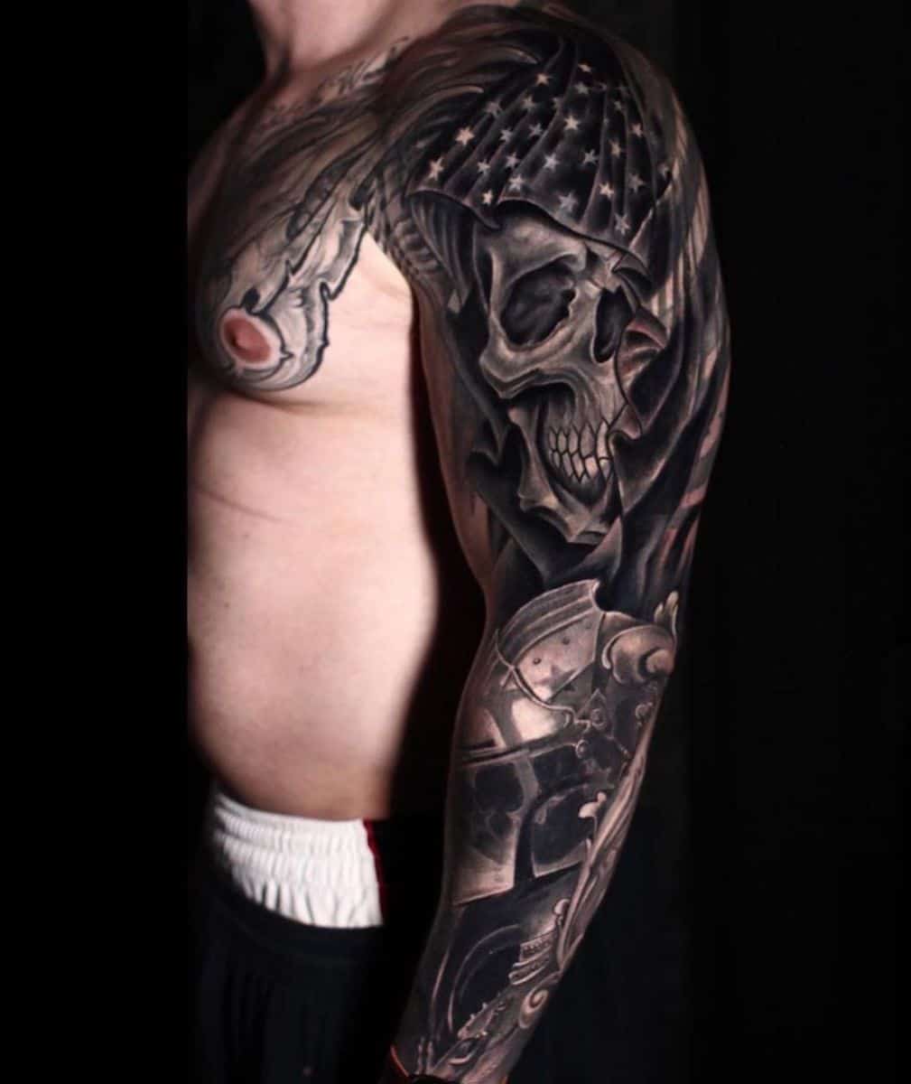 Man with a detailed full-sleeve tattoo featuring a skull, stars, and a mechanical design on a black background