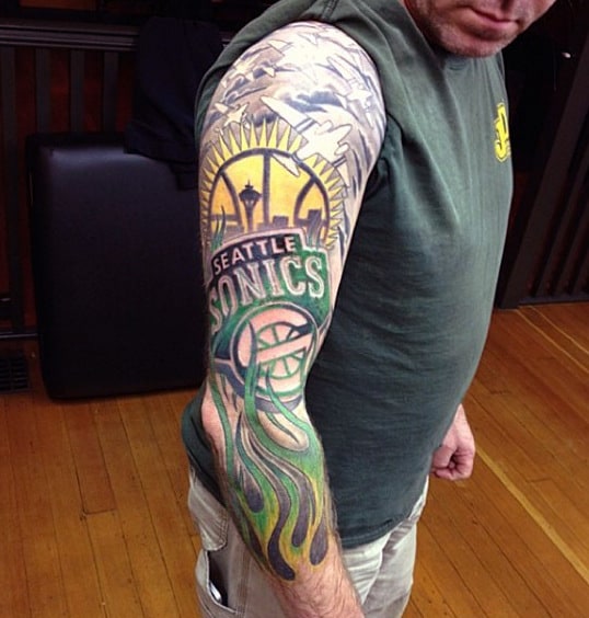 Individual with a detailed "Seattle Sonics" basketball tattoo on their upper arm