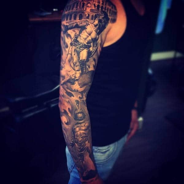 Man with a meticulously detailed gladiator-themed full sleeve tattoo on his right arm