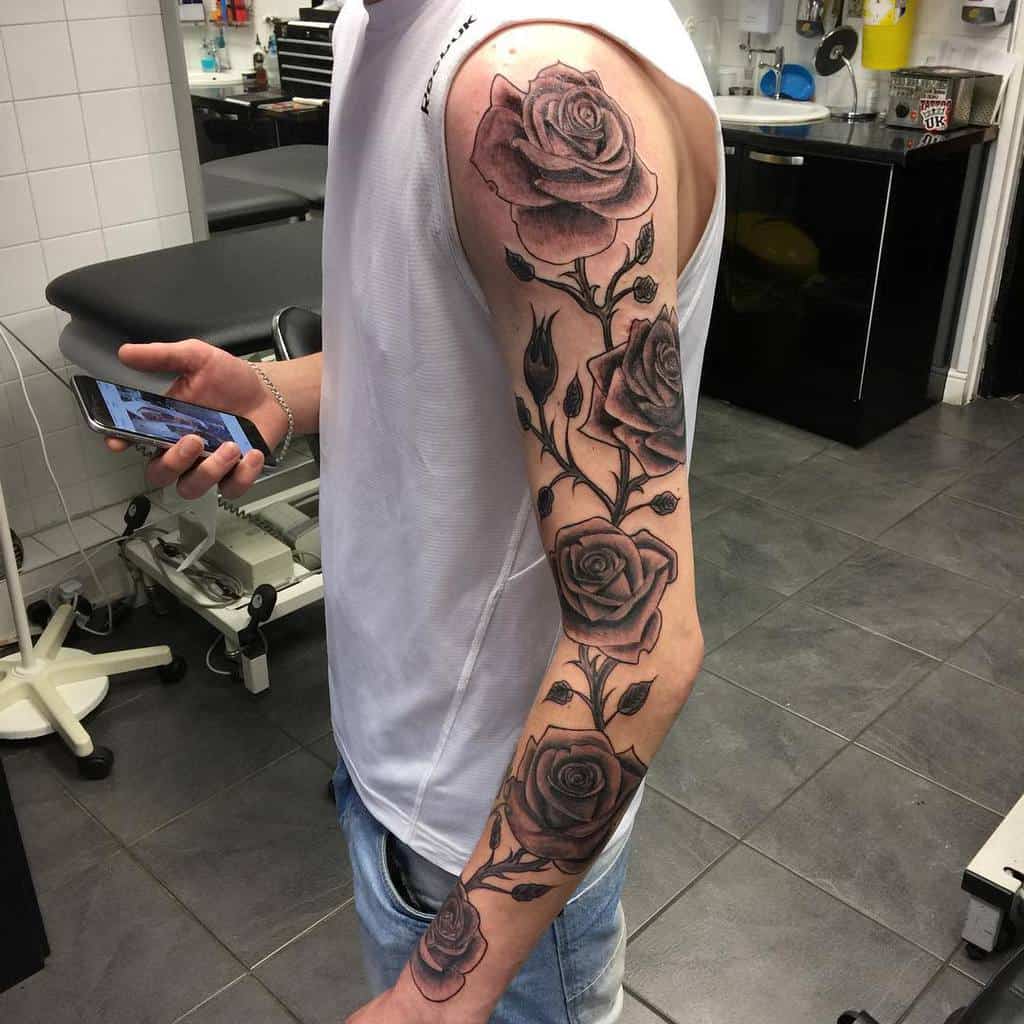 A man with an intricately designed rose tattoo sleeve