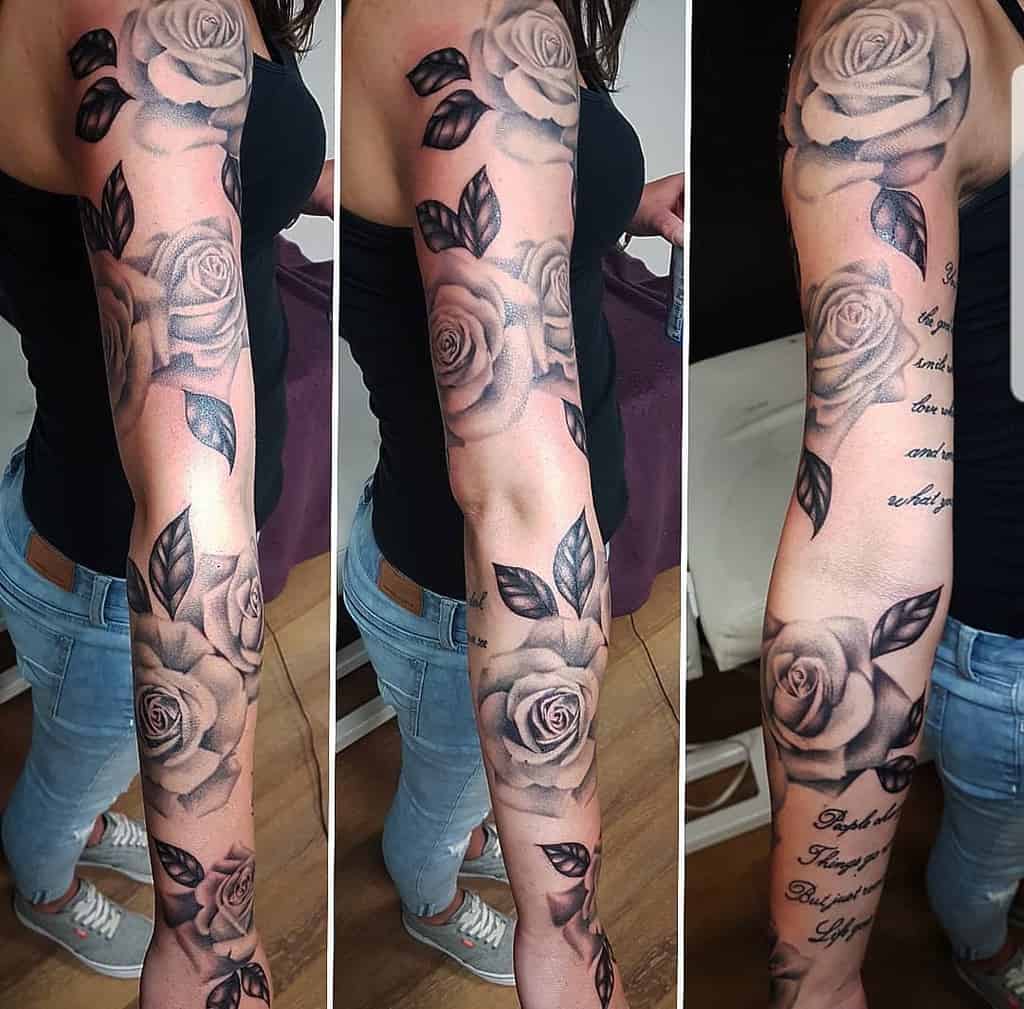 A stunning full sleeve tattoo adorns the woman's arm, intricately blending roses with elegant script for a unique masterpiece